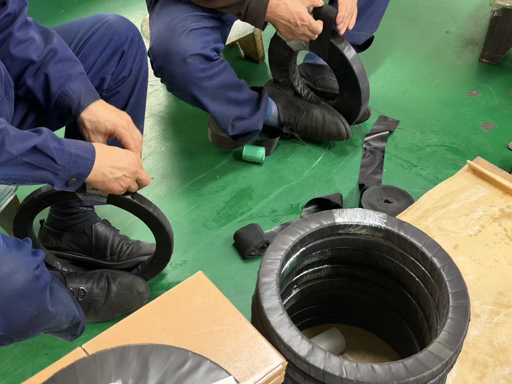 BY Bearings packing staff hand-wrapping crossed roller bearings with protective film before crating BY Bearings packing staff hand-wrapping crossed roller bearings with protective film before crating